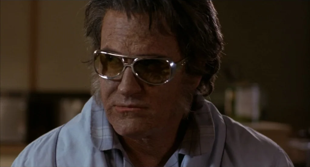 Bubba Ho-Tep (2002) movie still: closeup — An interior space with muted colors serves as the backdrop for an elderly man. The man sits in place…