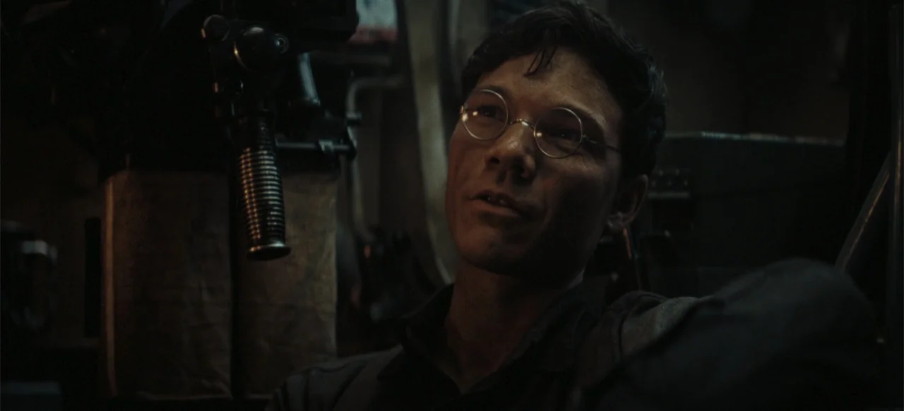 The Tank (2025) movie still: closeup — The interior of a military vehicle features dark metallic components and mechanical equipment visible. A…
