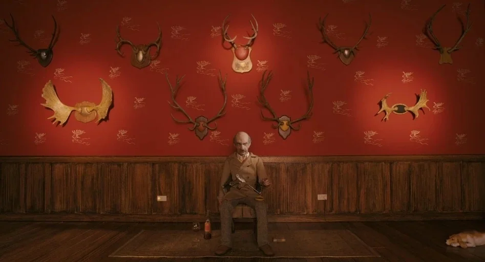 Fantastic Mr. Fox (2009) movie still: wide — A room with red wallpaper featuring repeating moose motifs and multiple mounted deer antlers. An…