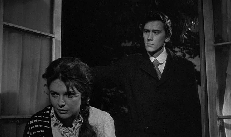 The Miracle Worker (1962) movie still: medium — A man and woman are positioned by an open window at night. The man stands directly behind the woman…