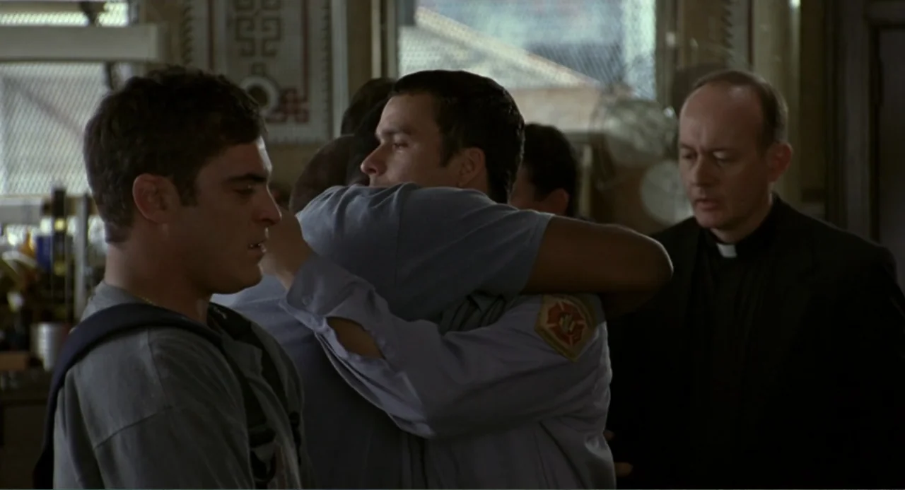 Ladder 49 (2004) movie still: medium — An interior fire station office features large windows and architectural trim in the background. Two men…