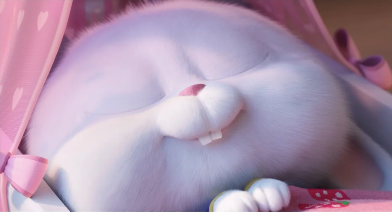 The Secret Life of Pets 2 (2019) movie still: closeup — A close-up of a white rabbit sleeping inside a pink fabric enclosure. The rabbit has its…
