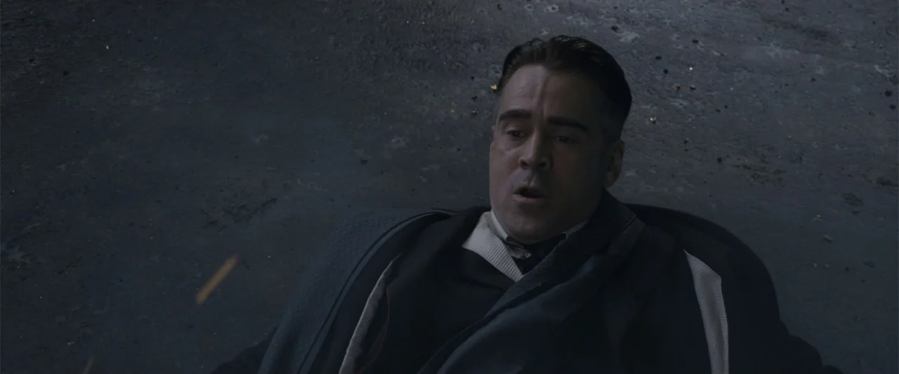 Fantastic Beasts and Where to Find Them (2016) movie still: medium — A man lies on a grey concrete surface surrounded by small debris. He stares…