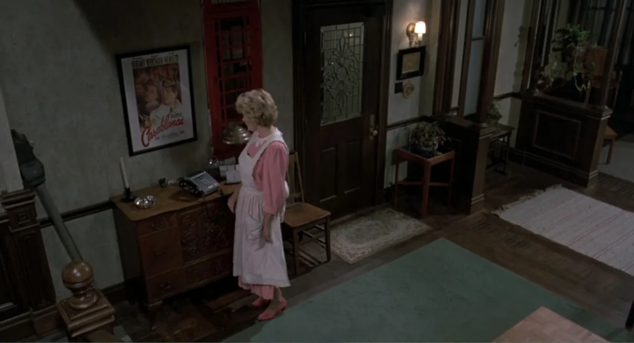 An Experiment in Fear: The Making of Monkey Shines (2014) movie still: medium — A domestic hallway features a wooden sideboard, a telephone, and a…
