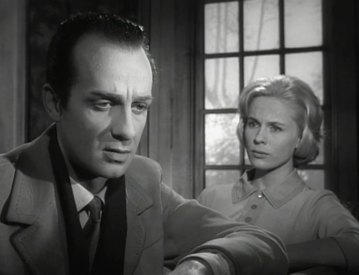 The Devil’s Eye (1960) movie still: medium — A pair of individuals sit in a room with a large window in background. The man faces slightly away…