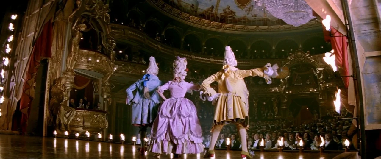 The Phantom of the Opera (2004) movie still: wide — An opulent gilded opera house features multi-tiered balconies and a crowded audience below.…
