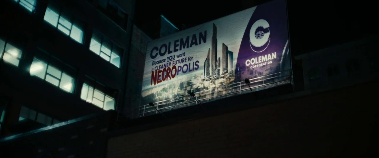 We Are Zombies (2023) movie still: establishing — A nighttime city view features a large rooftop billboard against dark, looming brick architecture.…