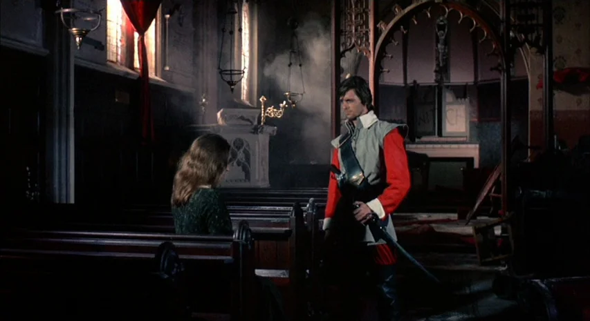 Witchfinder General (1968) movie still: medium — An aged interior of a church with wooden pews and stone altars. A man in historical attire stands…