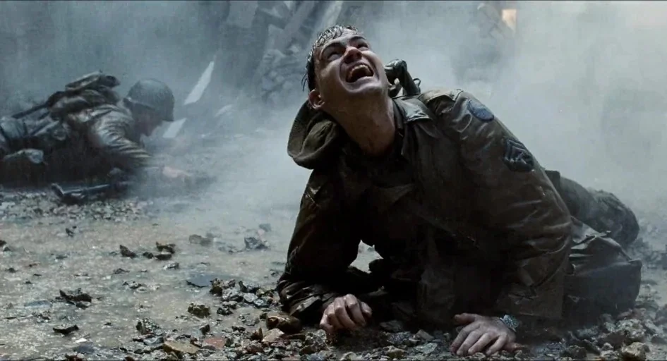 Saving Private Ryan (1998) movie still: medium — A rocky, debris-strewn ground is enveloped in thick gray smoke and atmospheric haze. A soldier…