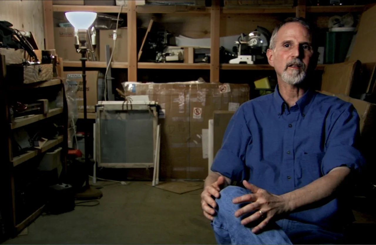 Dark Light: The Art of Blind Photographers (2009) movie still: medium — A cluttered storage space contains cardboard moving boxes and wooden…