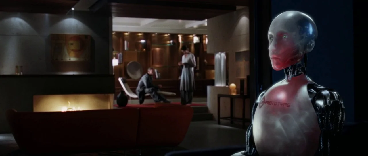 I, Robot (2004) movie still: medium — A modern, open-plan apartment features a fireplace and refined wood cabinetry in the background. A metallic…