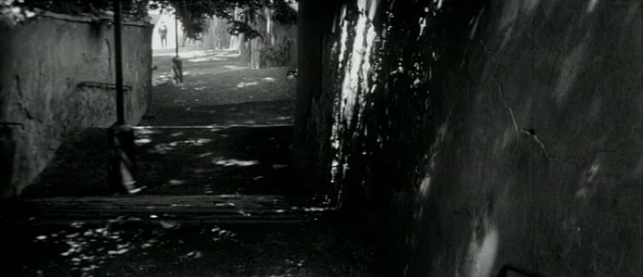 And The Fifth Horseman is Fear (1965) movie still: wide — A narrow stone passage is flanked by textured walls with visible cracks and decay.…