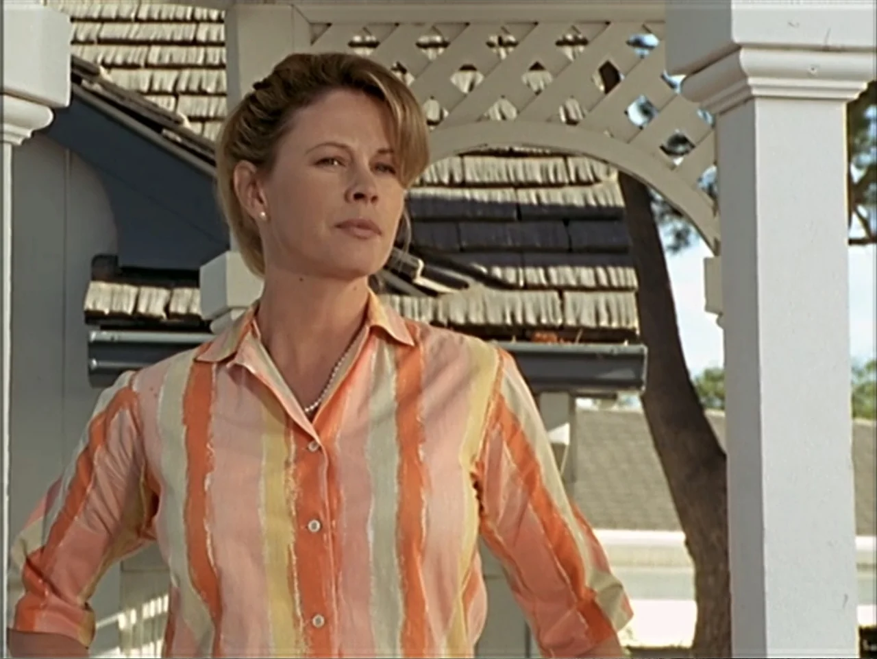 Just 4 Kicks (2003) movie still: medium — A woman stands within the white latticed structure of a wooden gazebo outdoors. She is positioned looking…