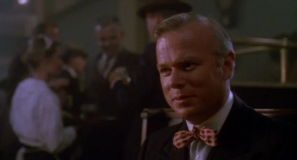 Eight Men Out (1988) movie still: closeup — A dimly lit dining establishment with other patrons blurred in the dark background. A middle-aged man…