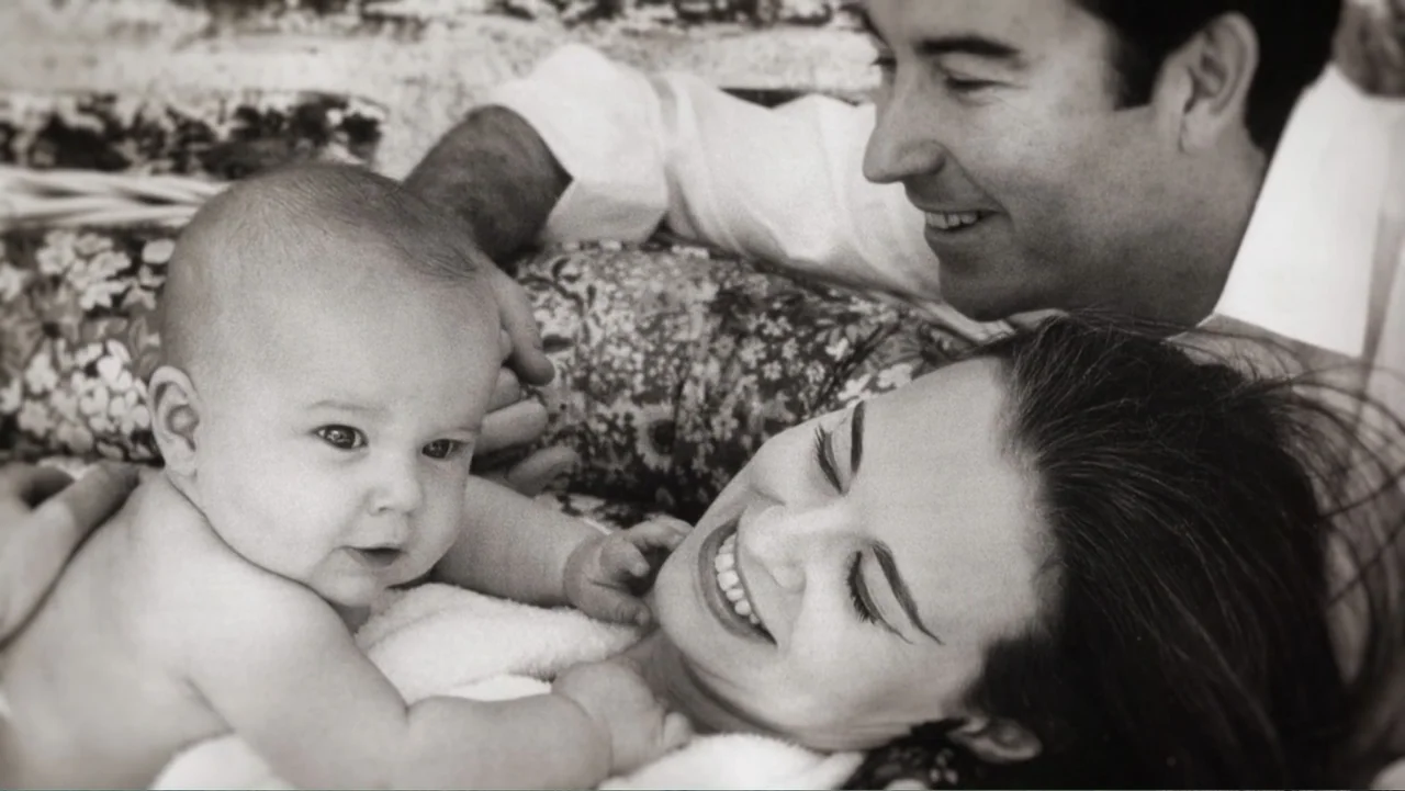 Nothing Left Unsaid: Gloria Vanderbilt & Anderson Cooper (2016) movie still: closeup — A close-up view showing a mother, father, and baby resting on…