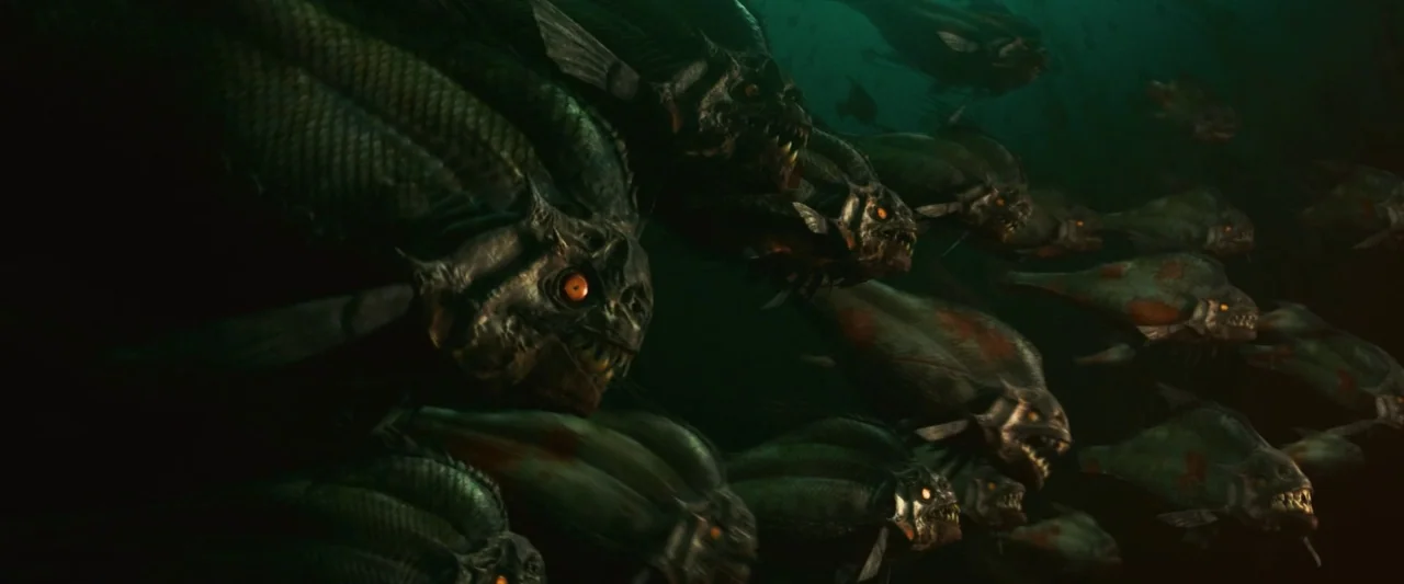 Piranha 3D (2010) movie still: wide — A dense school of predatory fish swims through the murky dark ocean depths. The creatures possess sharp teeth…
