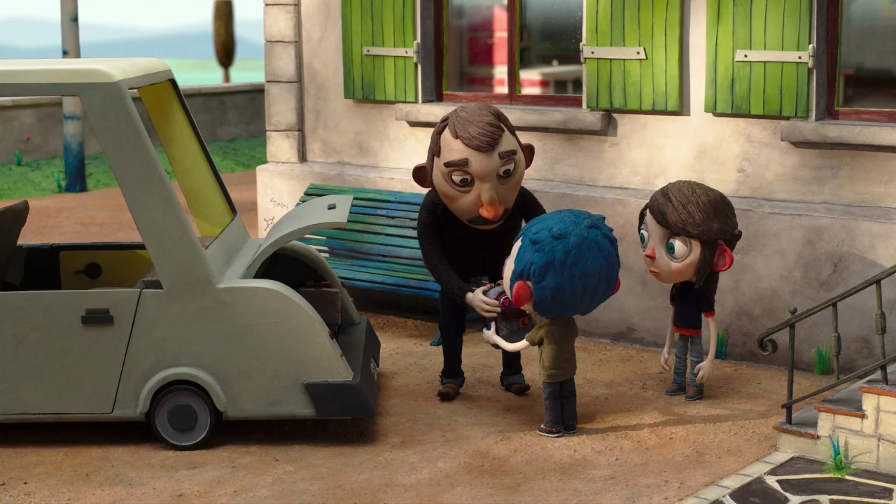My Life as a Zucchini (2016) movie still: fullbody — An exterior residential area with a stucco building and green shutters. Three figures stand…