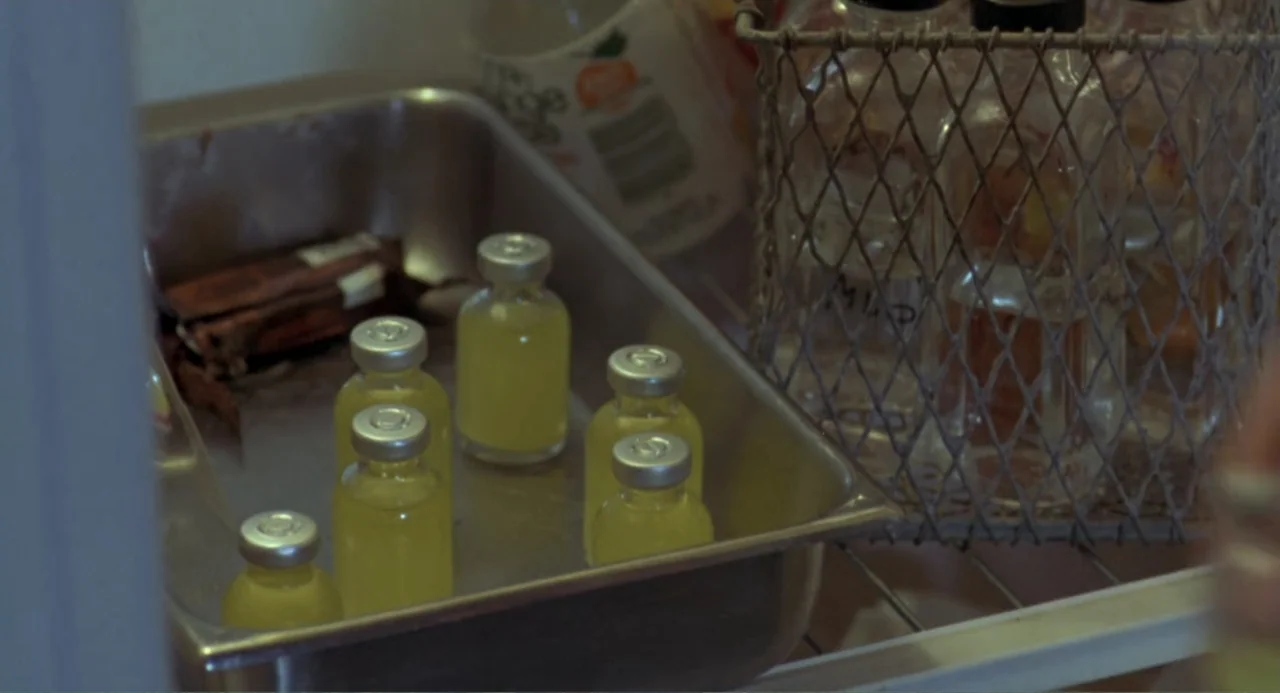 An Experiment in Fear: The Making of Monkey Shines (2014) movie still: closeup — A metal tray holds several small glass medical vials filled with…