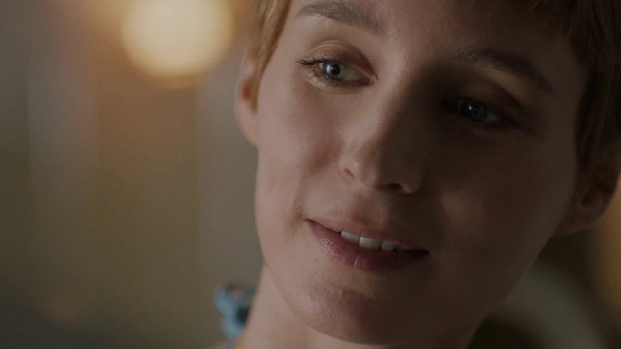Don't Worry, He Won't Get Far on Foot (2018) movie still: closeup — A close view of a woman with short hair in an indoor space. The subject looks…