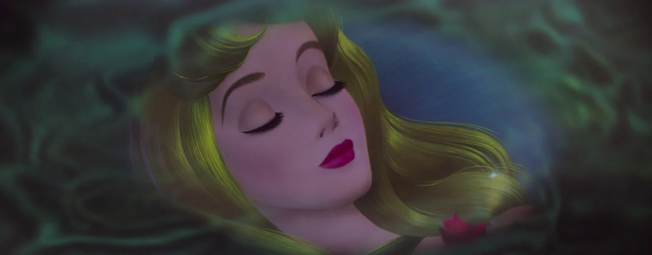 Sleeping Beauty (1959) movie still: closeup — A woman lies submerged in dark water surrounded by soft green ripples. She has her eyes closed while…