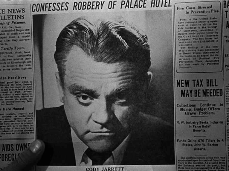 White Heat (1949) movie still: closeup — A close-up view of a black and white newspaper page featuring a portrait. The headline confirms a robbery…