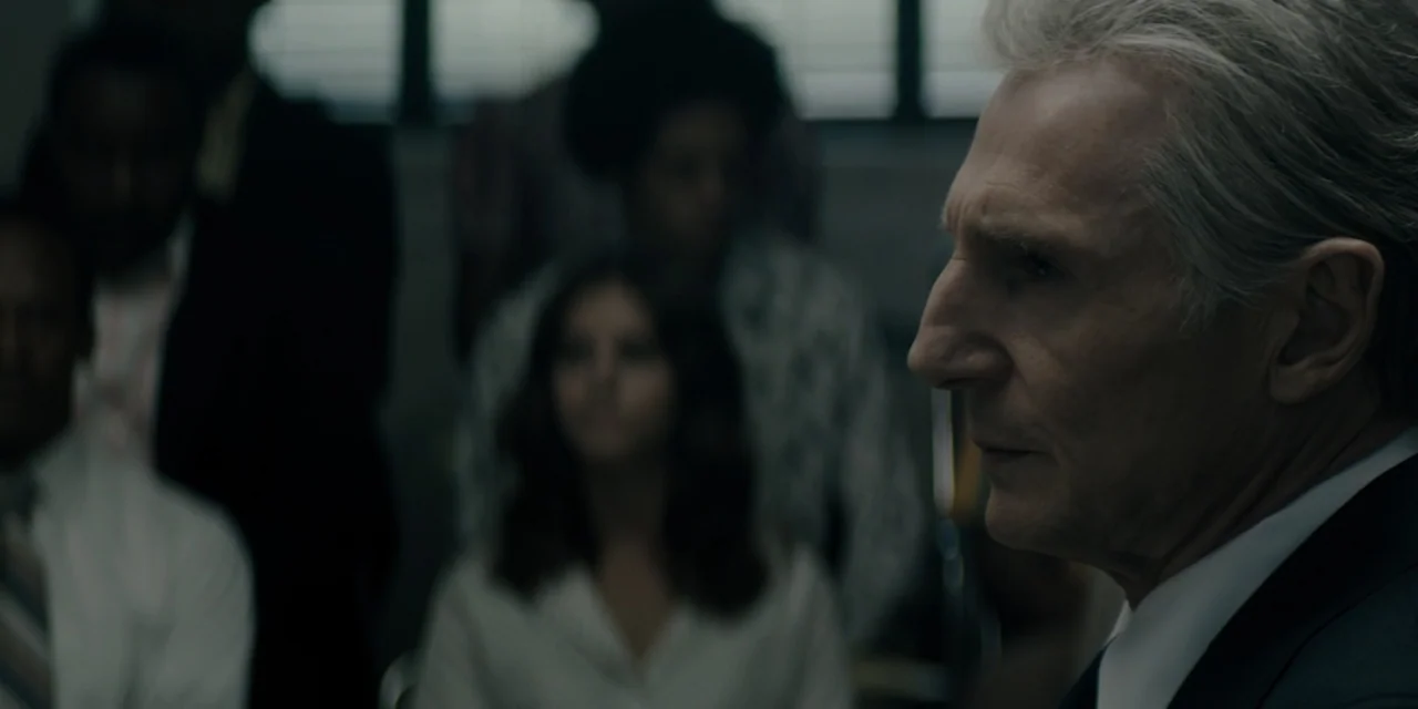 Mark Felt: The Man Who Brought Down the White House (2017) movie still: closeup — An office environment with several blurred people sitting in the…