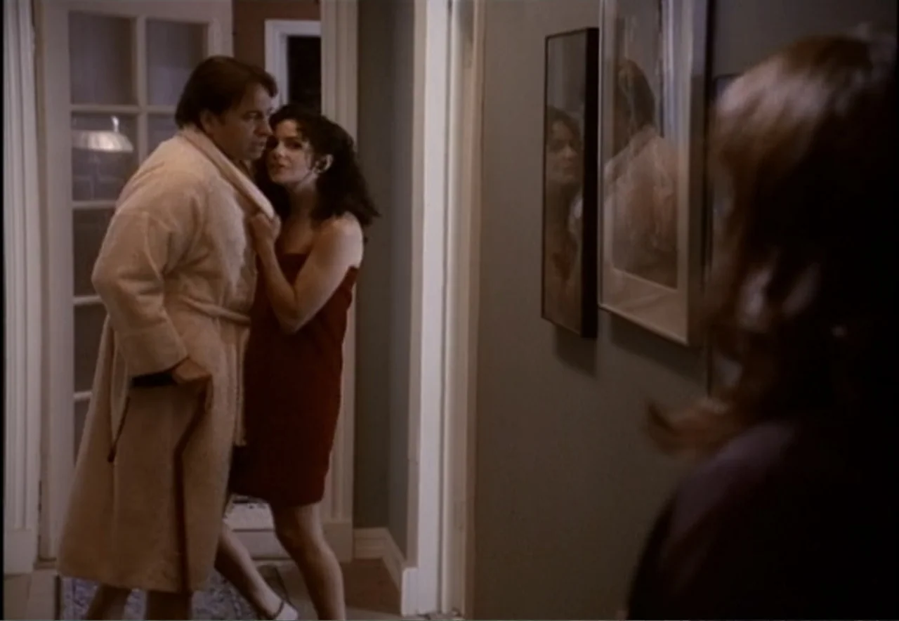 Chance of a Lifetime (1998) movie still: medium — A residential hallway features muted green walls decorated with vertical framed mirrors. An older…