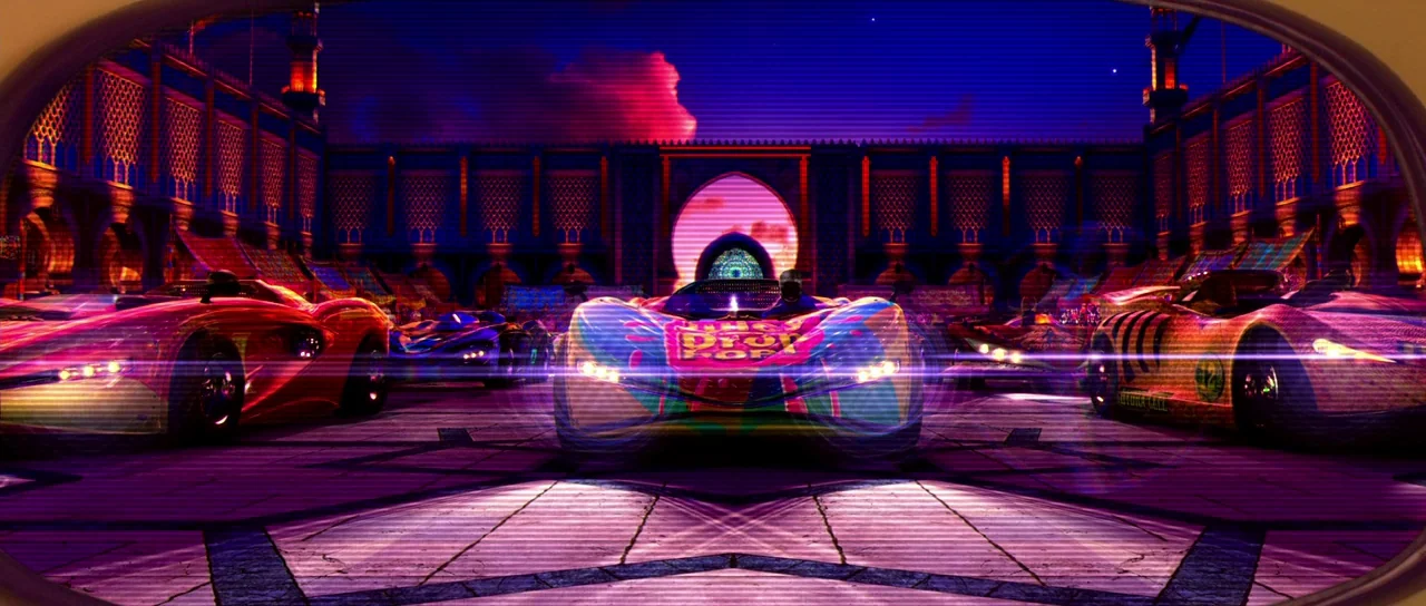 Speed Racer (2008) movie still: wide — A high-tech racing arena is illuminated by neon lights beneath a dark night sky. Multiple futuristic racing…