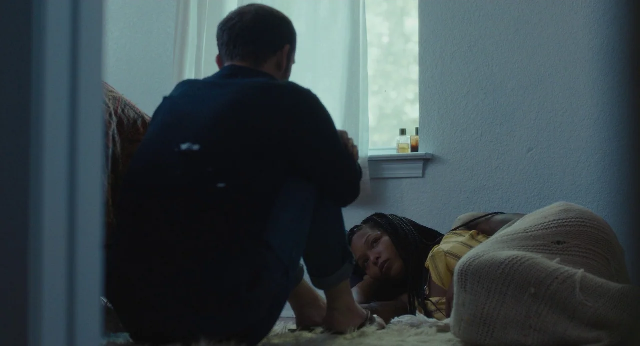 Test Pattern (2019) movie still: medium — A man and a woman rest together on a floor near a sunlit window. The woman lies on her side under a…