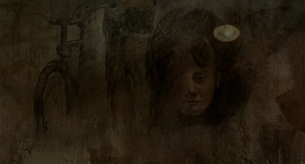 Furia (1999) movie still: closeup — A person's face emerges from shadows on a textured concrete wall. Beside the person, a faint charcoal drawing of…