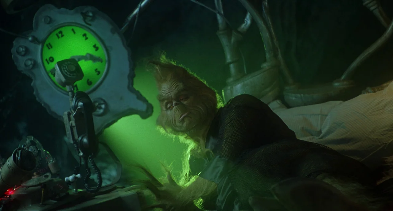 How The Grinch Stole Christmas (2000) movie still: medium — A dark, cavernous space features an intricate, unconventional wall-mounted clock with…
