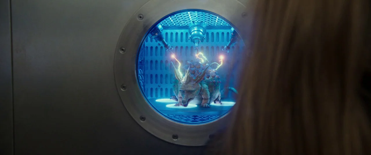 Valerian and the City of a Thousand Planets (2017) movie still: medium — A metal containment unit with a circular porthole reveals a laboratory…