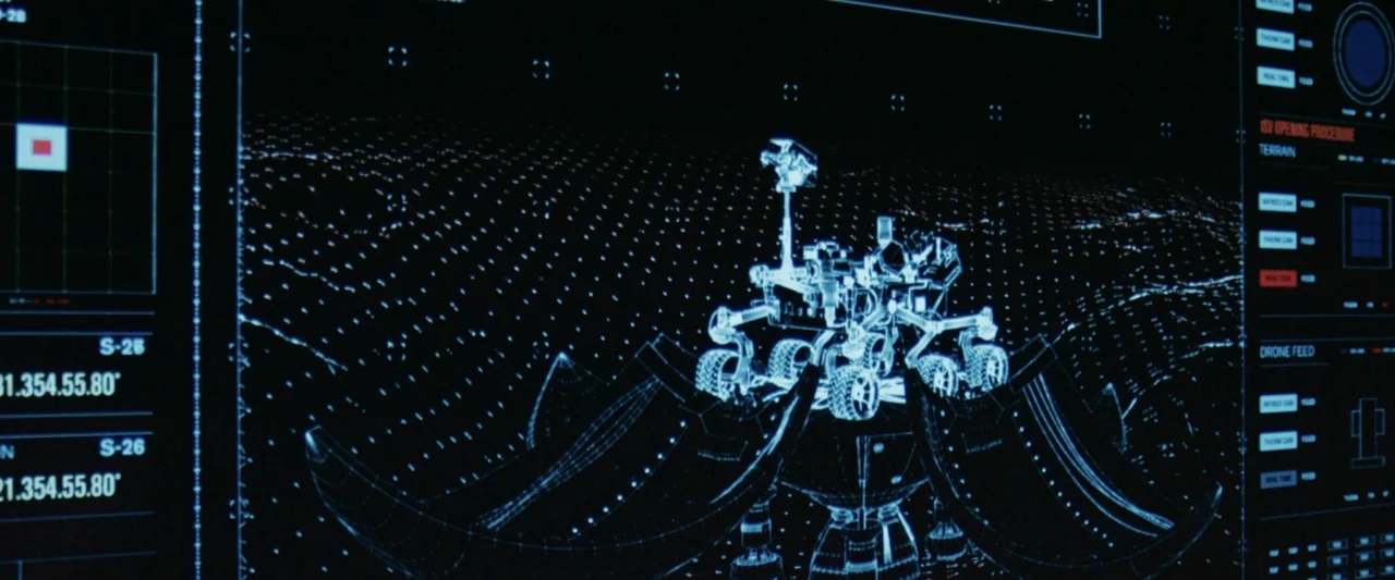 2036 Origin Unknown (2018) movie still: medium — A dark computer screen displays a blue holographic wireframe of a planetary rover vehicle. The…