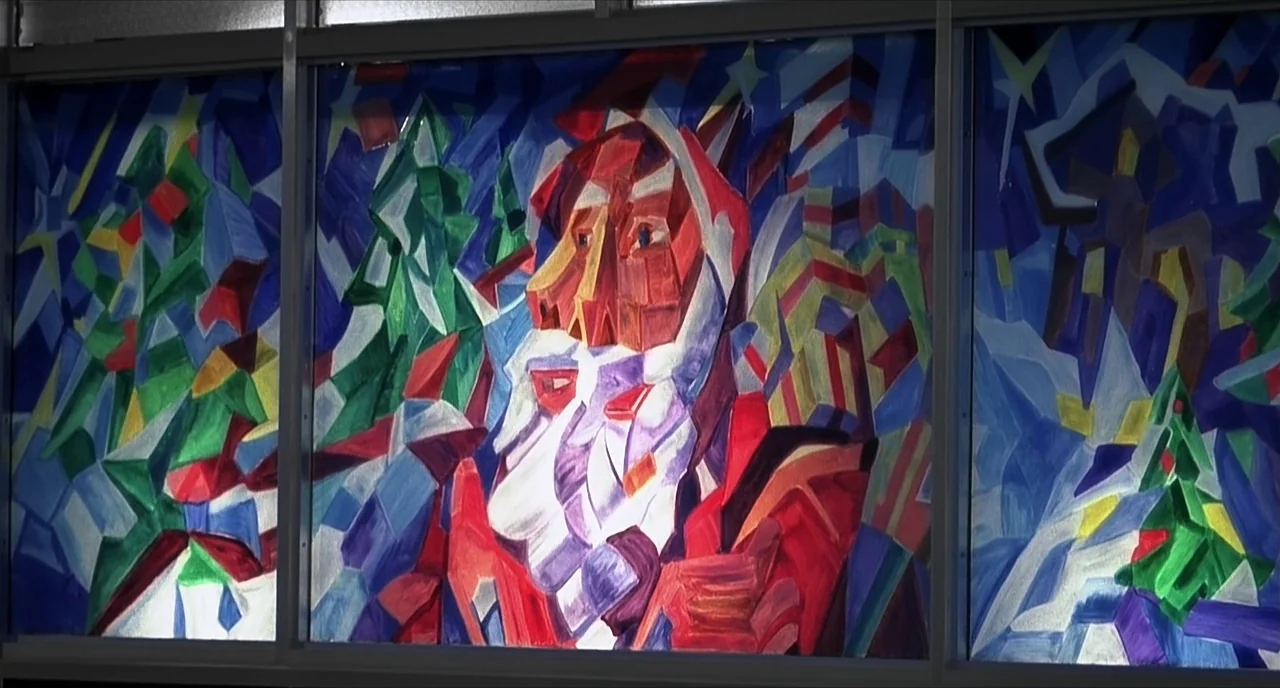Pleasantville (1998) movie still: medium — A tripartite geometric mural depicts a stylized Santa Claus figure with Christmas imagery. The painting…