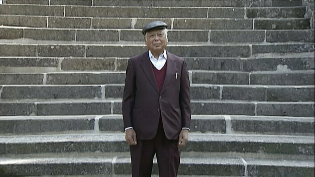 White Light/Black Rain: The Destruction of Hiroshima and Nagasaki (2007) movie still: fullbody — An elderly man stands in front of a long, wide…