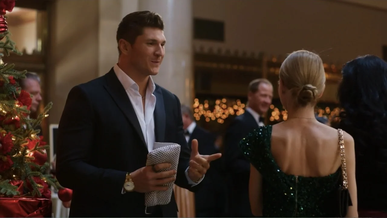 Christmas in the Spotlight (2024) movie still: medium — A well-lit indoor event space decorated for the holidays with a Christmas tree visible. A…