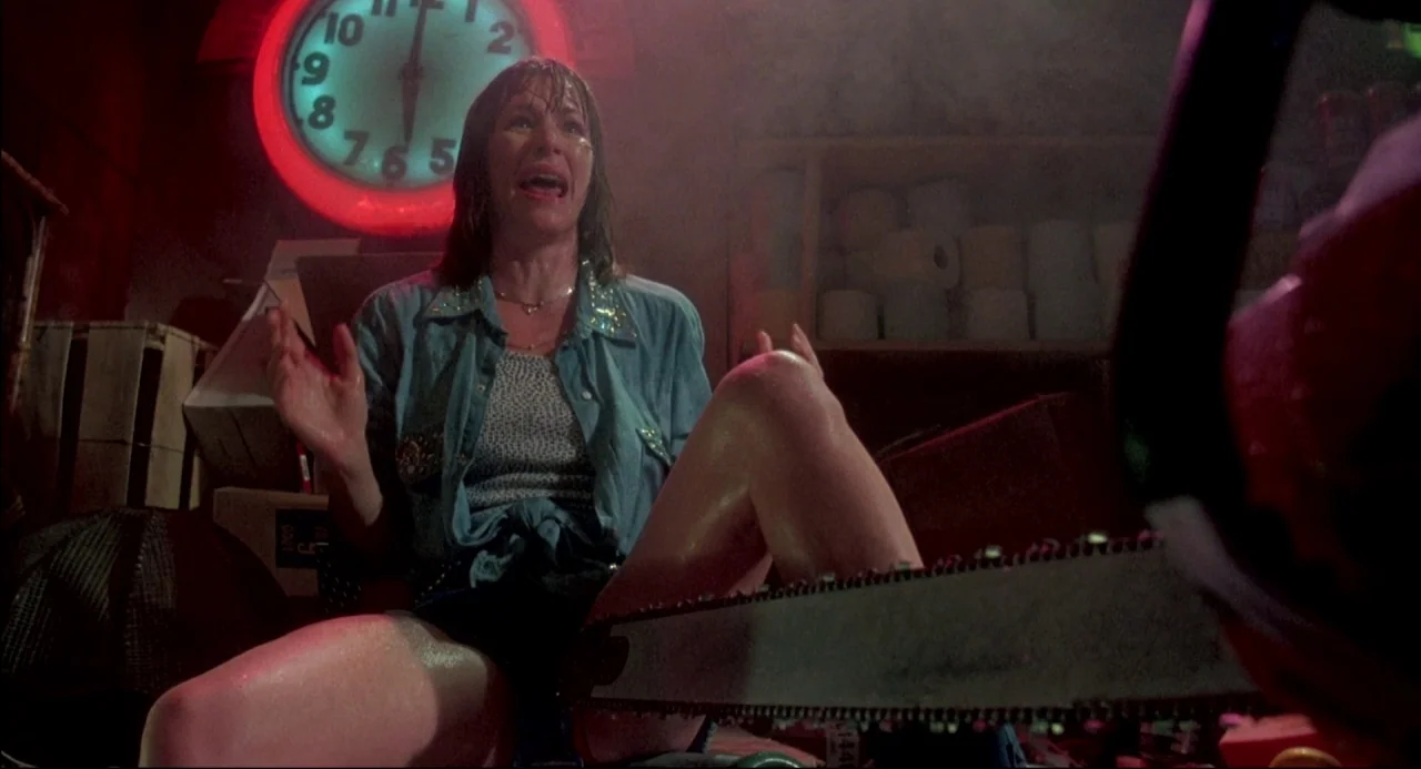 The Texas Chainsaw Massacre 2 (1986) movie still: medium — A cluttered storage room filled with cardboard boxes and stacked paper rolls. A…