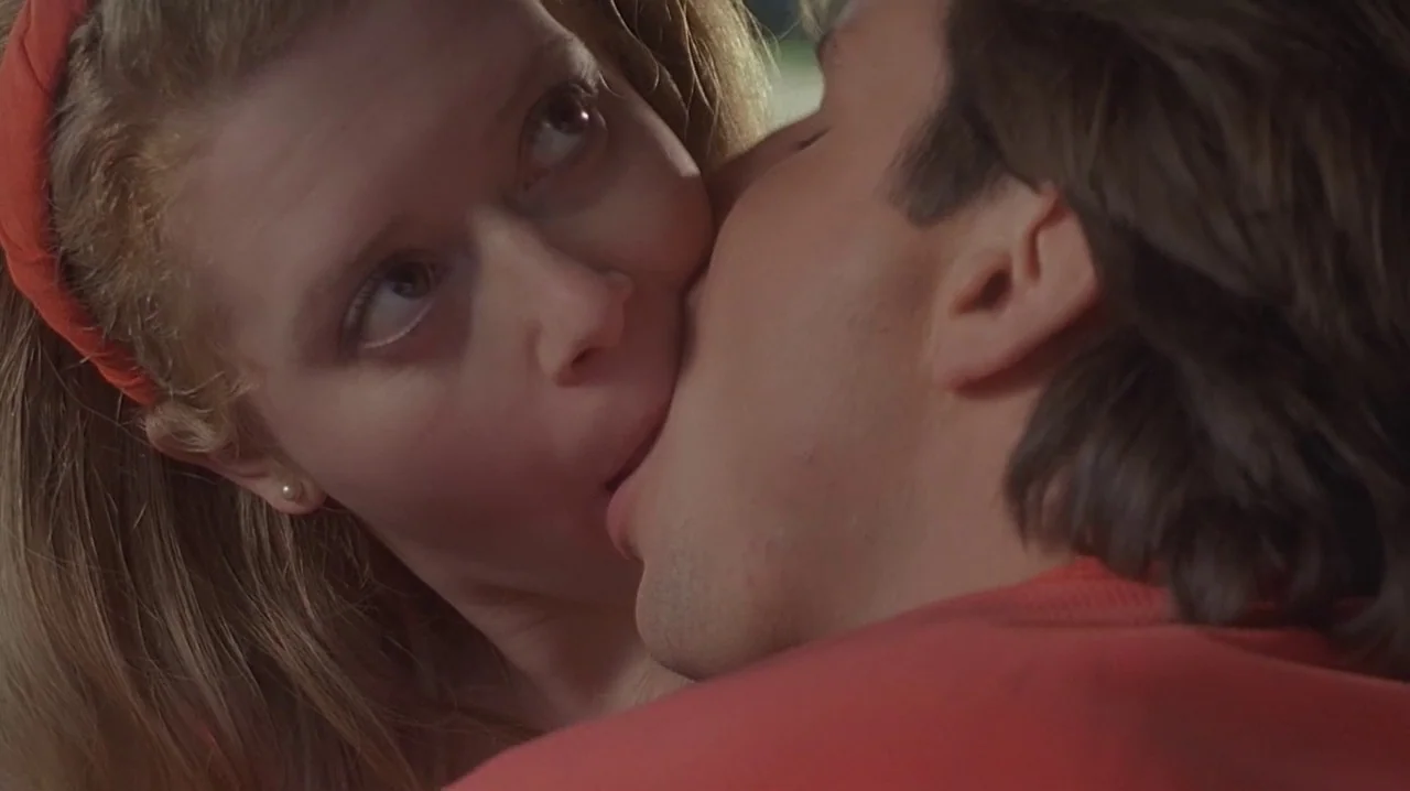 But I’m A Cheerleader (1999) movie still: closeup — The interior of a vehicle at night serves as the setting for the pair. A man kisses a woman on…