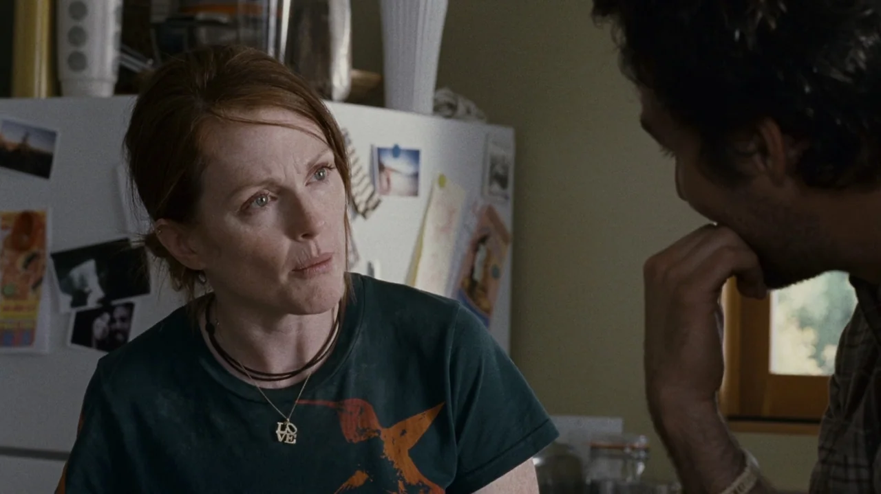 The Kids Are All Right (2010) movie still: medium — A residential kitchen interior features a refrigerator covered in magnets and photos. A…