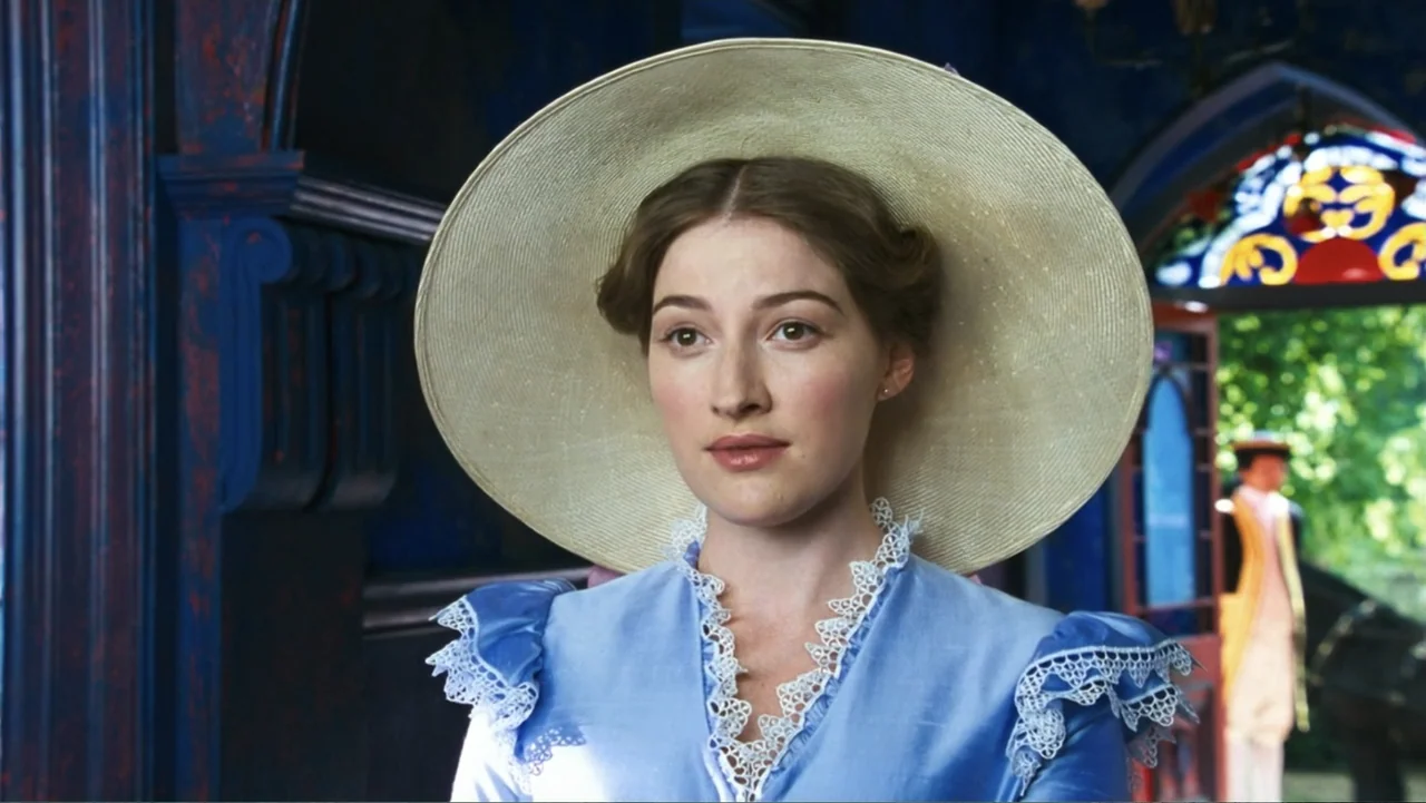 Nanny McPhee and the Big Bang (2010) movie still: medium — A woman in a blue dress stands before a dark blue painted interior entryway. A man in a…