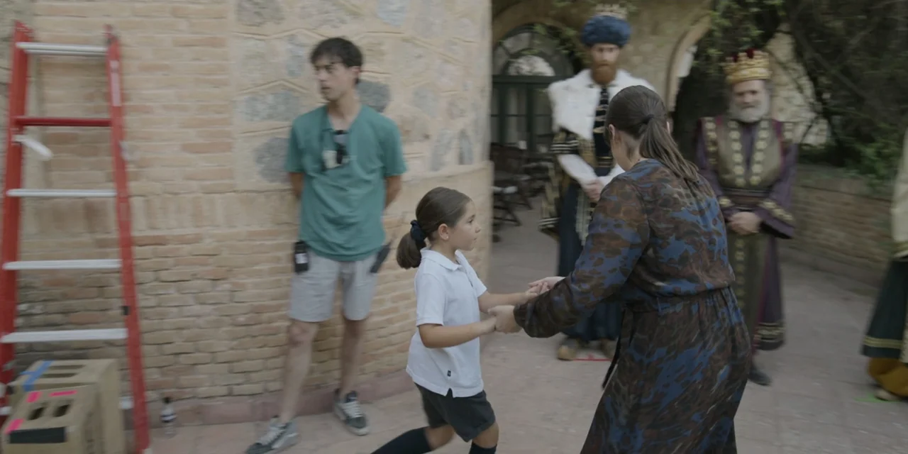 The Three Wise Men: The Truth (2022) movie still: medium — A stone courtyard features a brick wall with a red step ladder leaning against it. A…