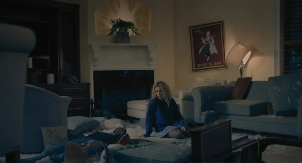 The Map of Tiny Perfect Things (2021) movie still: wide — A messy living room contains overturned furniture and scattered cushions covering the…