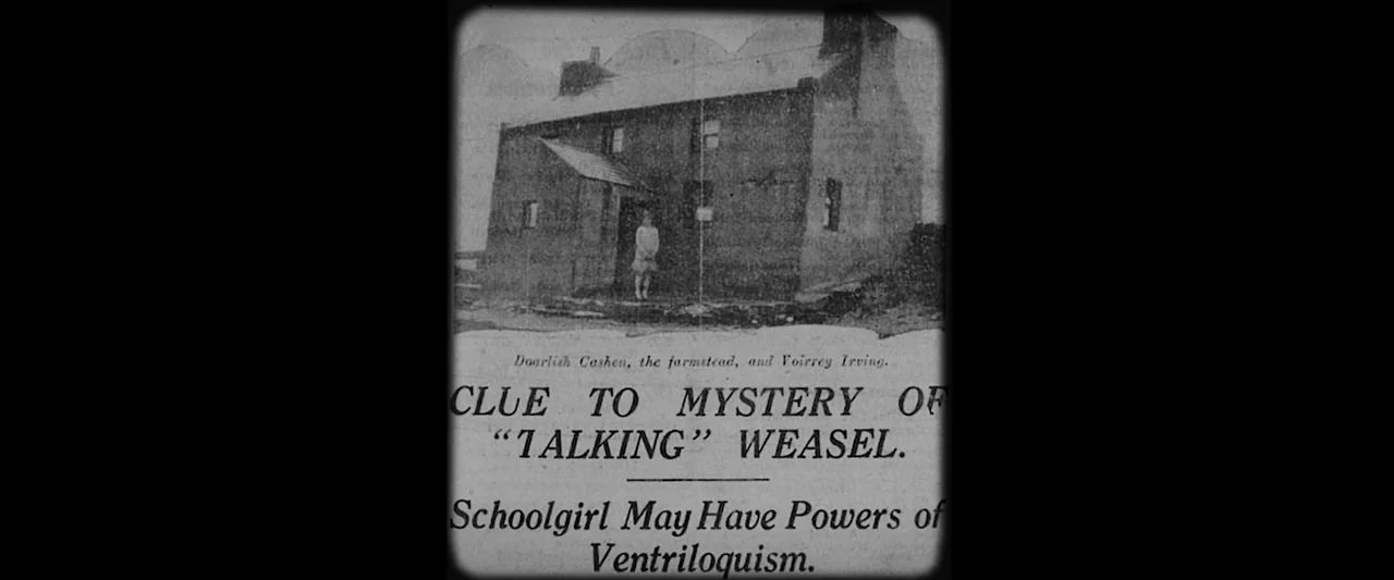 Nandor Fodor and the Talking Mongoose (2023) movie still: wide — A grainy black-and-white newspaper photograph shows a stone farmstead building with…