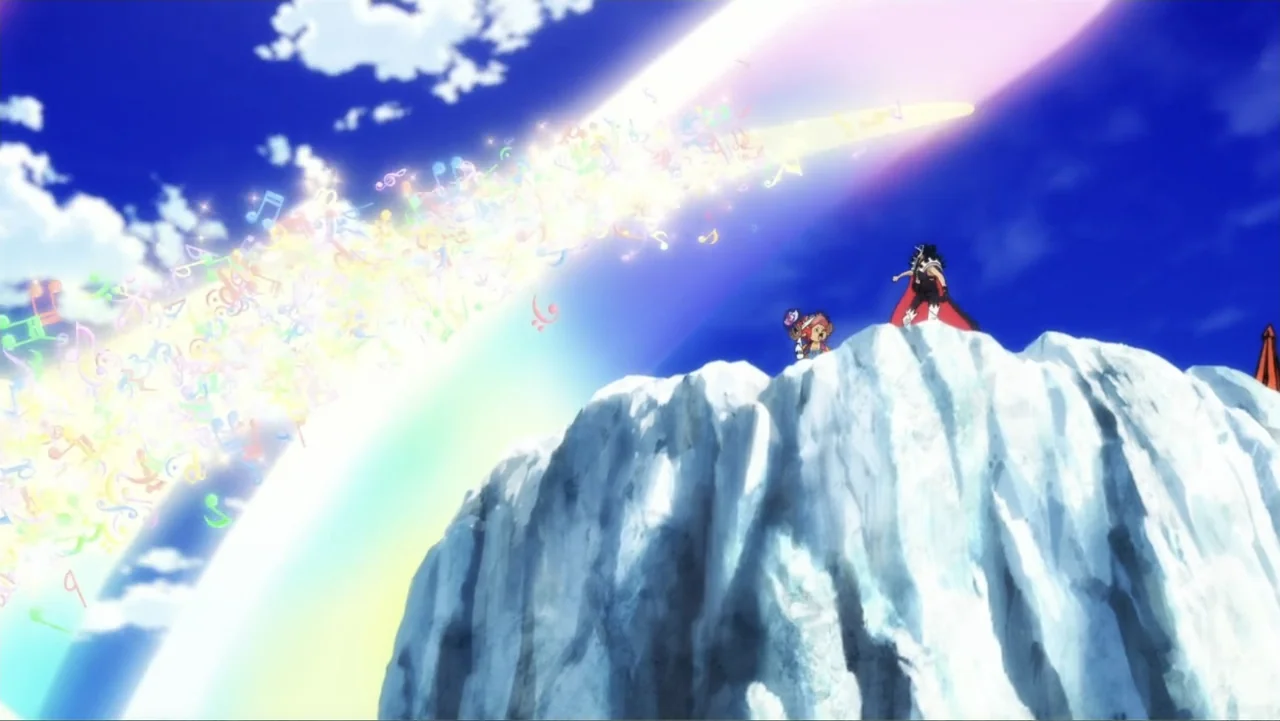 One Piece Film Red (2022) movie still: wide — A craggy mountain peak rises into a bright blue sky with white clouds. Two figures stand on the snow…