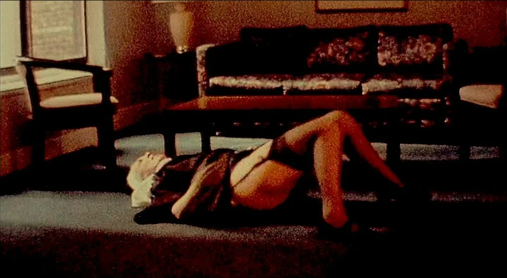 Julien Donkey Boy (1999) movie still: fullbody — A dimly lit space features a low-lying couch and an adjacent floor lamp. A woman wearing lingerie…