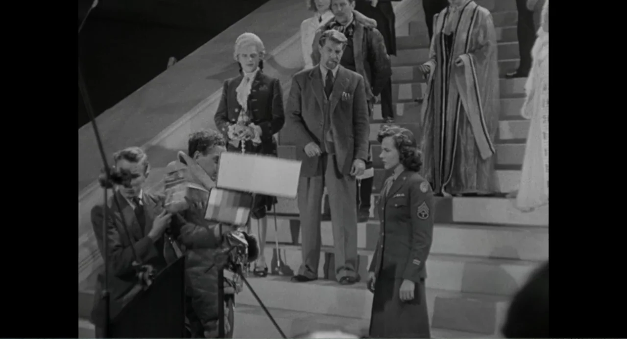Made in England: The Films of Powell and Pressburger (2024) movie still: fullbody — A film set features a large staircase with various costumed…