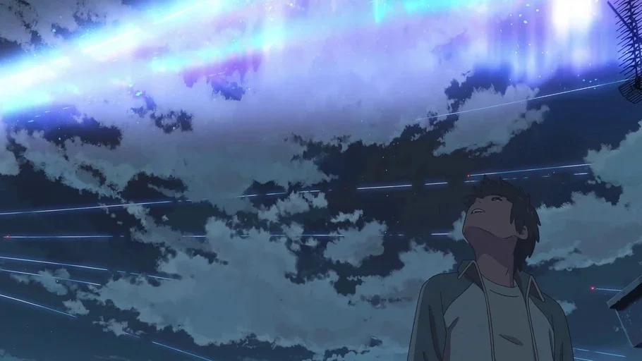 Your Name (2016) movie still: medium — A night sky filled with clouds and glowing streaks of blue light. A young male looks upward from a rooftop.