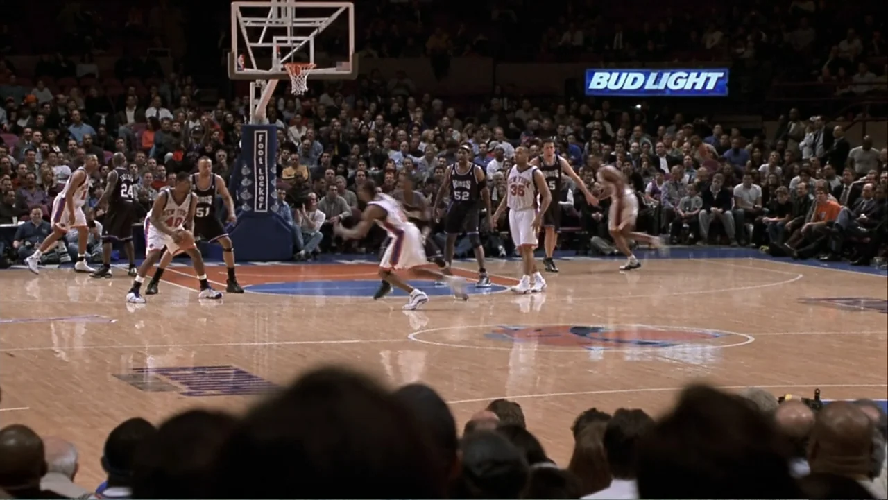 How to Lose a Guy in 10 Days (2003) movie still: wide — A professional basketball court filled with athletes is surrounded by a large stadium crowd.…