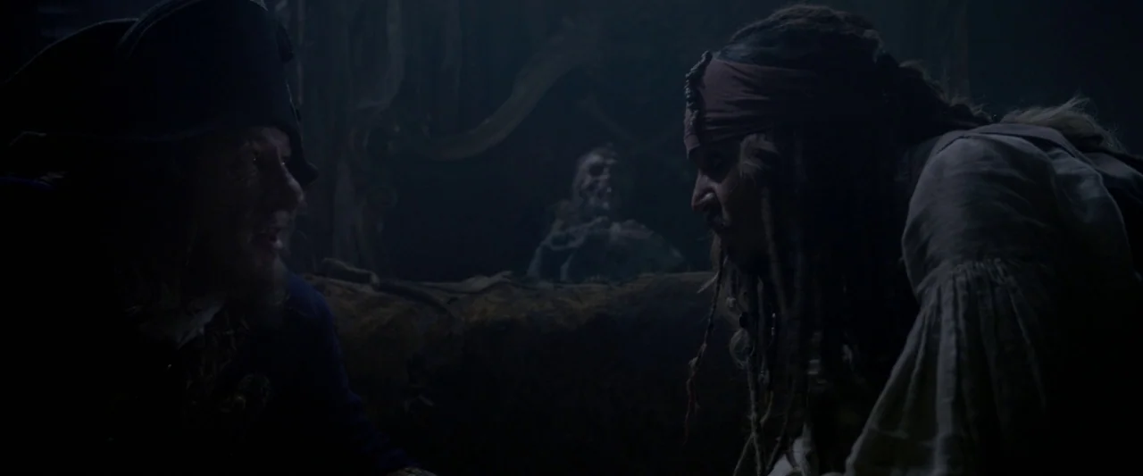Pirates of the Caribbean: On Stranger Tides movie still: medium — A dark, cramped ship interior features wood paneling and aged, ornate furnishings.…