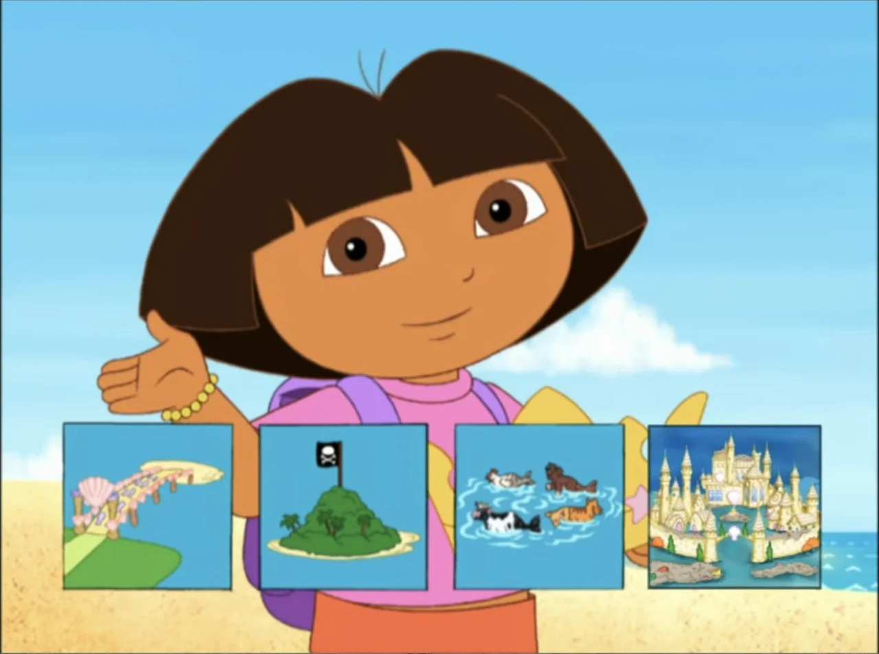Dora the Explorer: Mermaid Adventures (2025) movie still: medium — A cartoon girl stands on a sunny beach with clear blue sky and sand. She gestures…